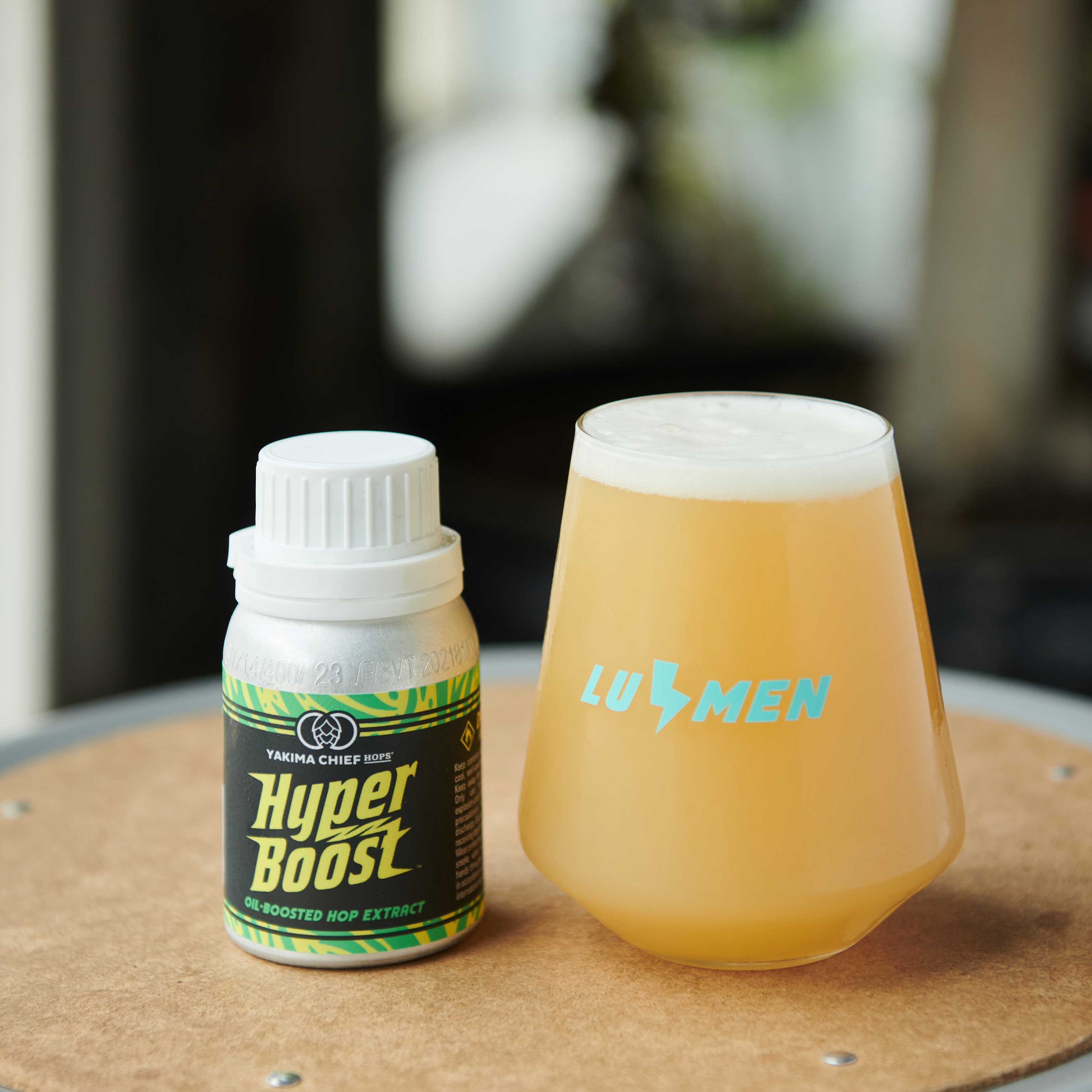 Hyperboost container and beer in a glass labeled lumen