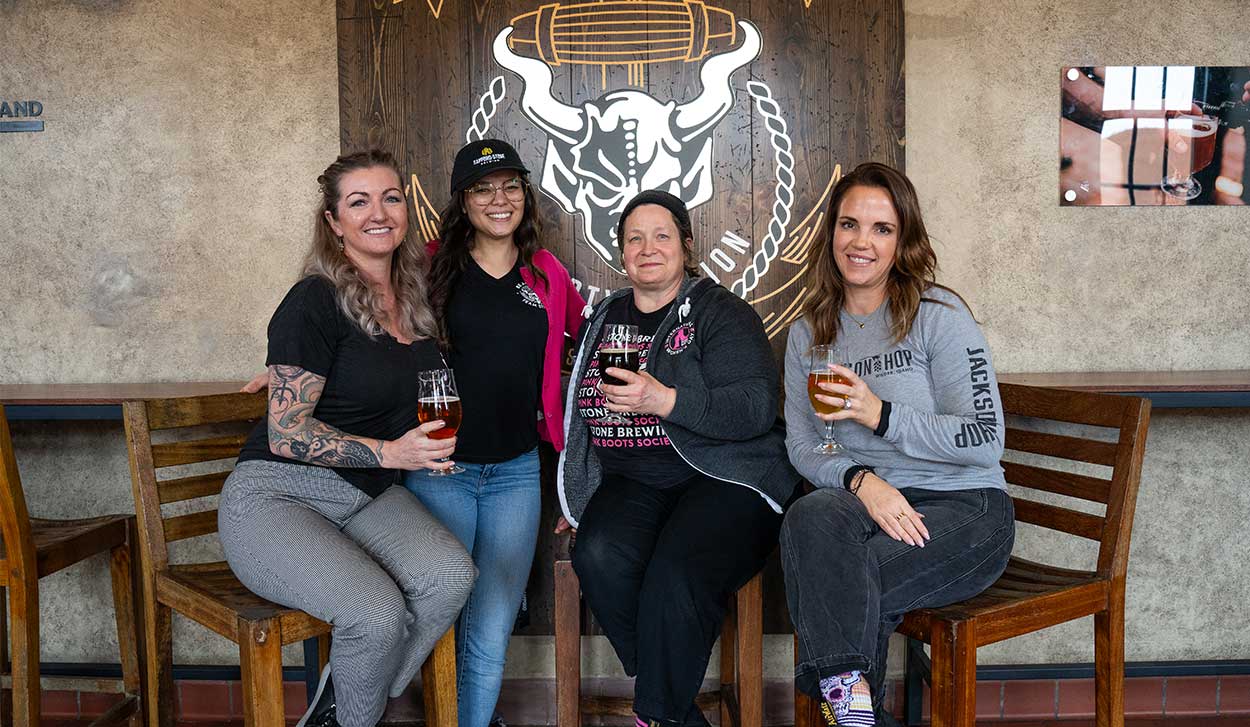 Sapporo-Stone Brew Day participants standing together with beers in hand