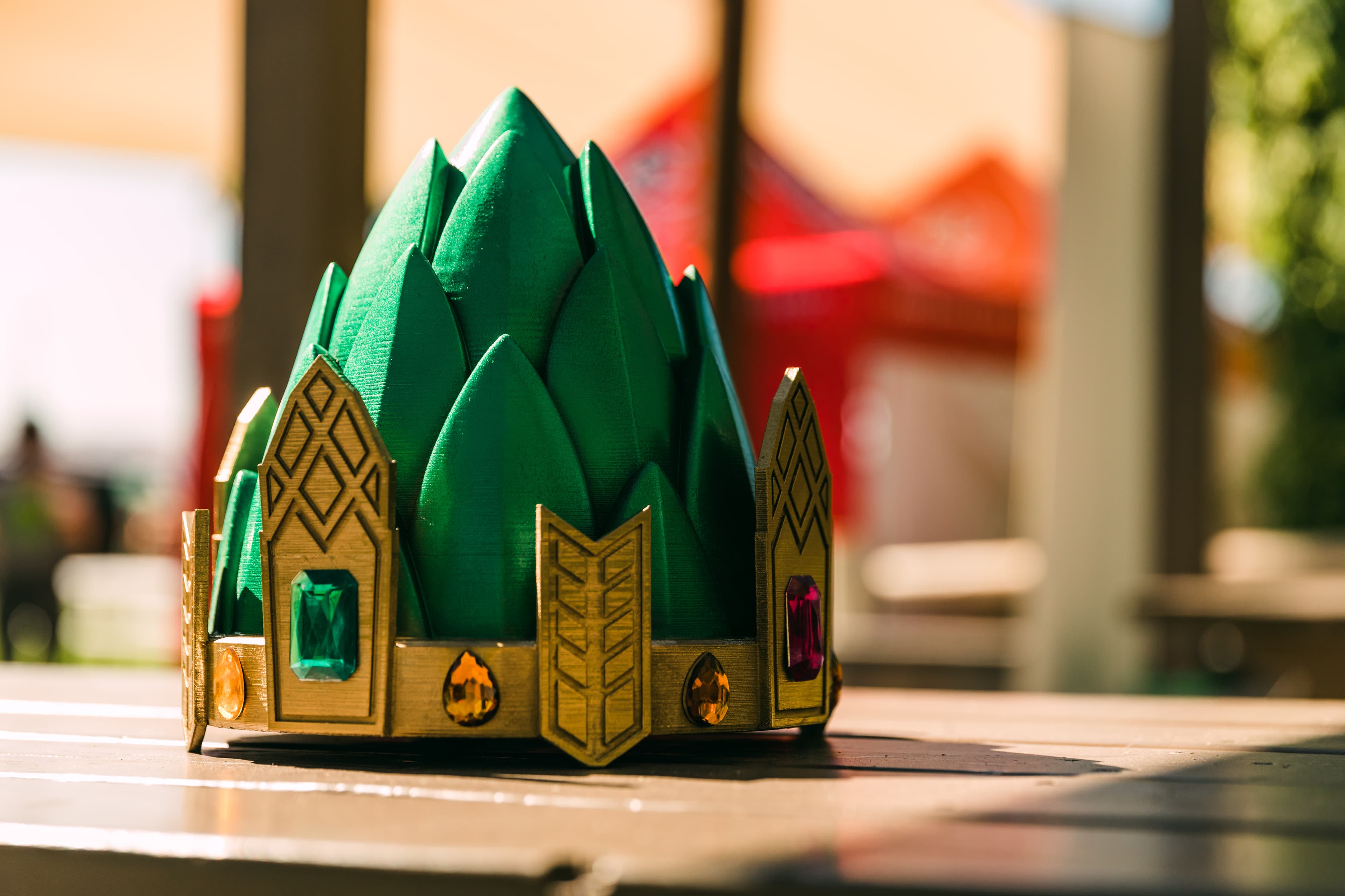 green and gold hop shaped crown on a table