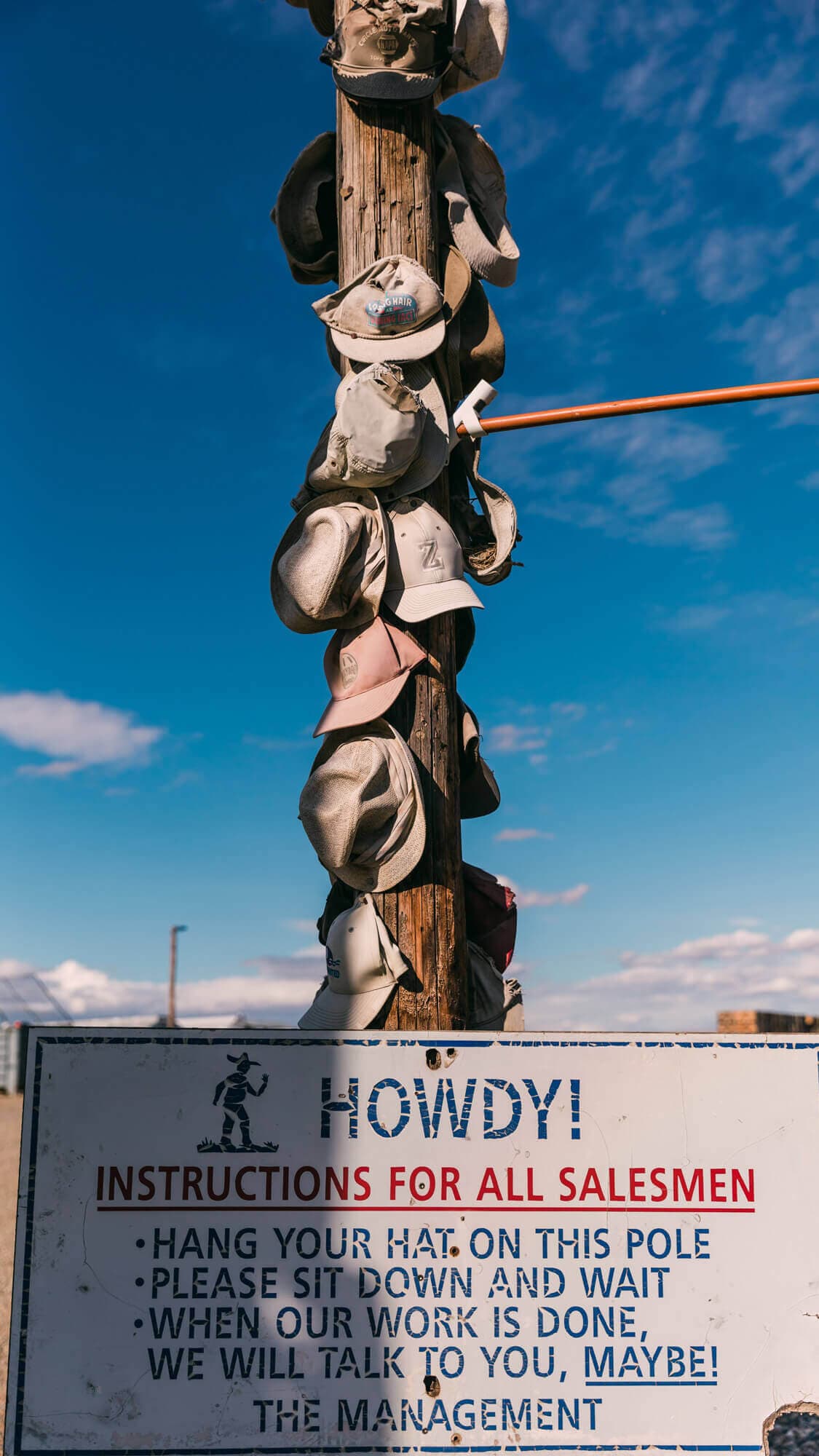 Image of a hop pole with hats hanging on it
